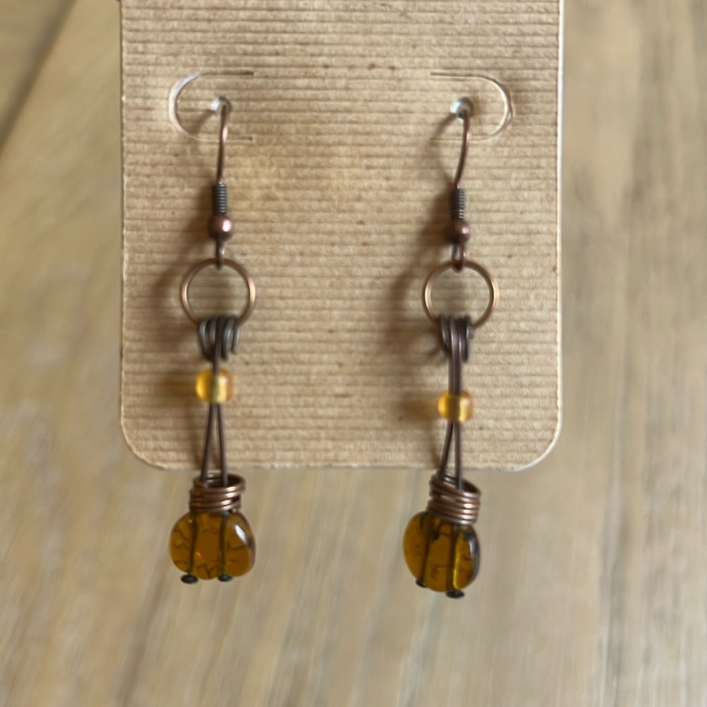 Bohemian wire wrapped earrings in brushed copper finish with amber glass beads